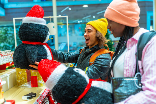 Young couple enjoying christmas holiday decoration shopping in store