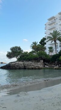 Waves playing in picturesque Cala Ferrera bay on Mallorca island. Evening on the empty beach in Spain.