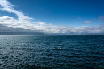 Obraz premium Panoramic view of the sea and blue sky with clouds.