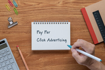 There is notebook with the word Pay Per Click Advertising. It is as an eye-catching image.