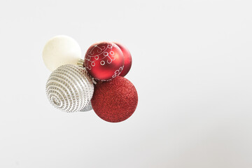 A collection of decorative Christmas balls, in different colors and textures, stuck together on a white background.