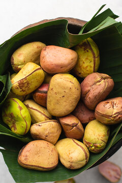 Overhead view of kola nut on leaf, top view of fresh kolanut