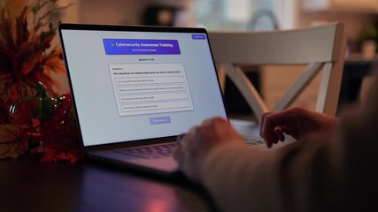 Middle Aged Man Working from Home Takes IT Security Awareness Training from Kitchen Table - Cybersecurity Education for Remote Employees Concept