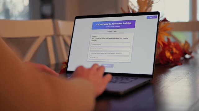 Middle Aged Man Working from Home Takes IT Security Awareness Training from Kitchen Table - Cybersecurity Education for Remote Employees Concept