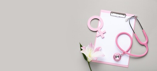 Clipboard with symbol of woman, lily flower and stethoscope on grey background with space for text