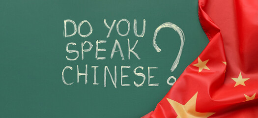 Text DO YOU SPEAK CHINESE? and flag on green chalkboard