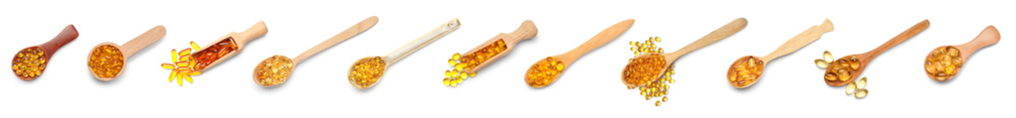 Set of scoops and spoons with vitamin E capsules on white background