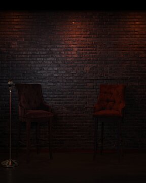 Dark stage with two chairs and a microphone against a brick wall background for a performance