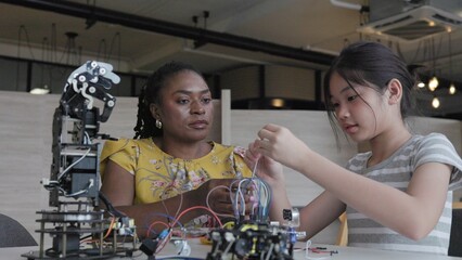 Teachers teach students about building and designing robots in the classroom.