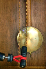 ASMR concept: Recording the calming tick-tock sound of a vintage grandfather clock pendulum.
