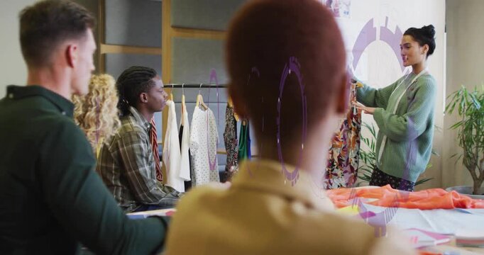 Fashion team examining patterned dress, presenter raising garment with purple overlay for review