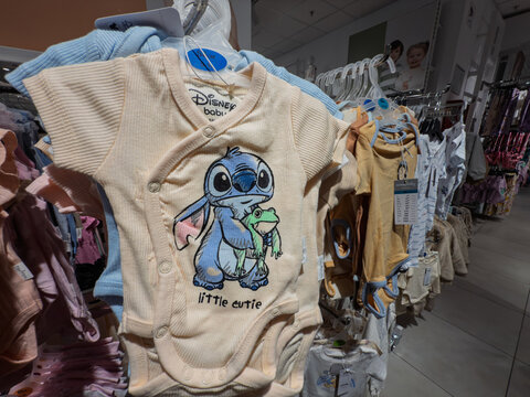 BELGRADE, SERBIA - MAY 17, 2025: Baby romper with Stitch hangs on a Disney baby clothes rack in a supermarket in Belgrade, on licensed Lilo and Stitch merchandise in the childrenswear section.