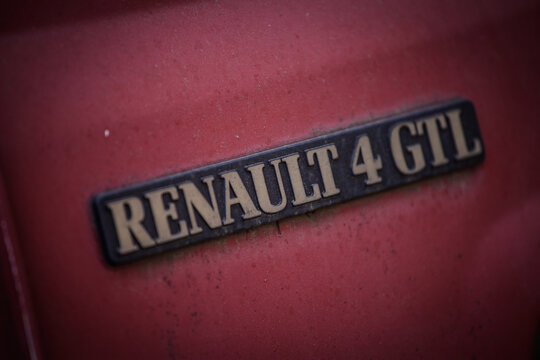 BELGRADE, SERBIA - OCTOBER 19, 2025: Detail of a Renault 4 GTL badge on a red body panel in Belgrade. The Renault 4, or R4 or 4L is a vintage french car from renault designed in the 1960's.