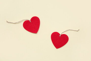 Heart shaped decorations with ropes on beige background. Valentine's Day celebration