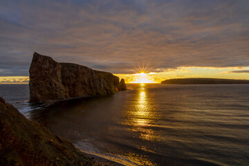 Breathtaking sunrise over Perce Rock, Gaspe Peninsula, Quebec. Captured in stunning morning light, this iconic landmark offers a serene and picturesque view.