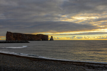 Breathtaking sunrise over Perce Rock, Gaspe Peninsula, Quebec. Captured in stunning morning light, this iconic landmark offers a serene and picturesque view.