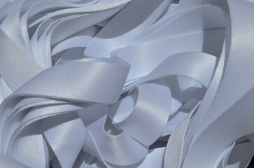 a bunch of stacked white ribbons. satin textured lanyard ribbons