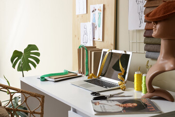 Interior of room with comfortable workplace of clothes stylist