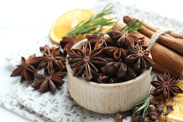 Different spices, dry orange slices and fresh rosemary for mulled wine on table, closeup