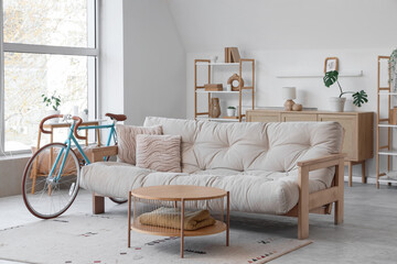 Interior of living room with bicycle, sofa and table
