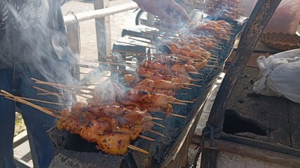 Traditional Sate Ayam being Cooked on Skewers | Smoking Barbecue of Indonesian Street Food | Marinated Chicken Skewers on a Grill