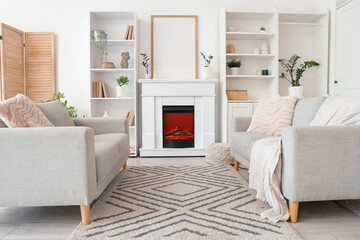 Fototapeta premium Beautiful fireplace in stylish interior of living room, closeup