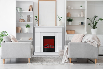 Fototapeta premium Fireplace and sofas in interior of light living room