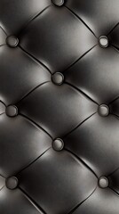 Obraz premium Elegant black leather cushion exhibits a luxurious quilted pattern with sophisticated button details