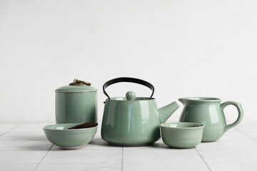 Green tea set on white wooden table