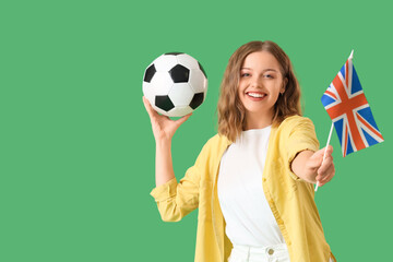 Young woman with UK flag and soccer ball on green background