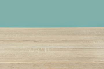 Empty wooden surface against mint background