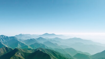 Fototapeta premium Serene Mountain Landscape with Layers of Blue Hills and Soft Mist Under a Clear Sky