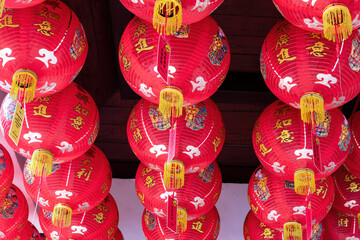 Red decorated Chinese paper lanterns, hanging from the ceiling in the Tempat Ibadat Tridharma temple in Singaraja, Bali, Indonesia. 
