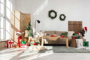 Interior of living room with sofa, table and Christmas gifts