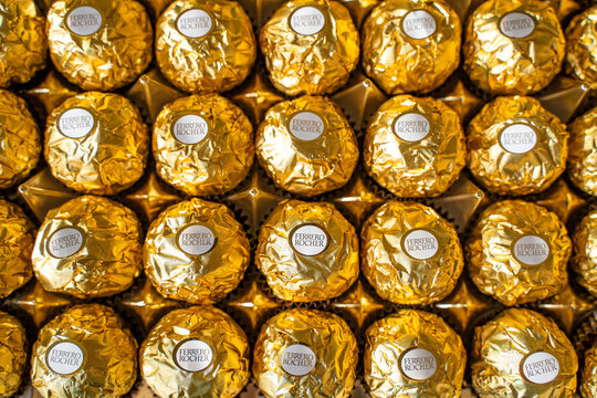 Close-up of Ferrero Rocher Chocolate on Golden Wrapper. Candies Top View.