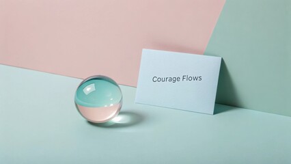 Elegant Composition of Glass Sphere with Colorful Background and Inspirational Card Encouraging Courage and Confidence