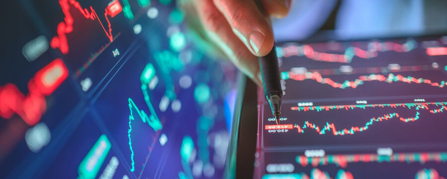 Analyzing financial data on a tablet screen, stock market trends and trading