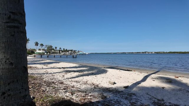 Static shot of Summa Beach Park in West Palm Beach Florida looking northeast over the Intracoastal Waterway showing the white sand and calm waters.