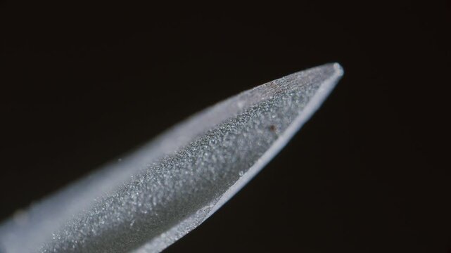 Syringe needle sharp tip under microscope