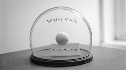 Glass Dome Displaying a Golf Ball with a Message about Maintaining Mental Space in Black and White Setting