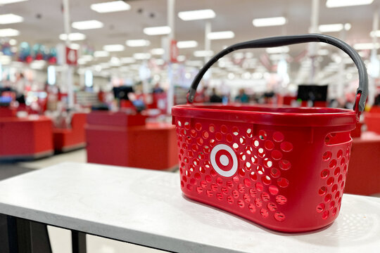 Northville, Michigan, USA - Nov 16, 2025 : Red Target shopping basket inside a retail store. The background is blurred, showing shoppers and merchandise for shopping, consumerism, and brand identity.