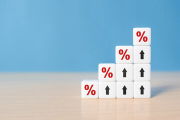 Closeup wood cubes with percentage symbol, Percent and upwards increasing arrows on dice. Financial interest mortgage rates increase or price commission raise, growth business, finance tax