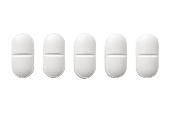 Five white, oval pills in a row