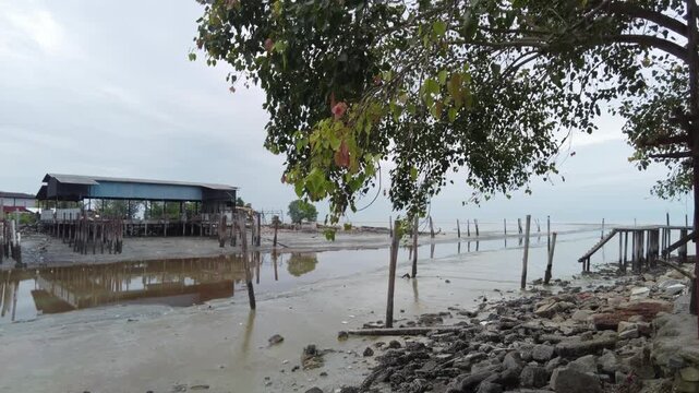 A tranquil view of an unoccupied fishing dock close to the Sekinchan Sea.