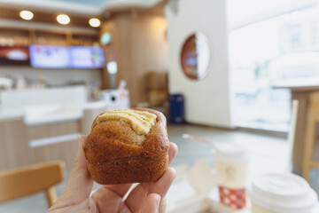 Delicious homemade mini banana cake and fresh pastry served on a white plate with a cup of coffee for a sweet gourmet breakfast meal 