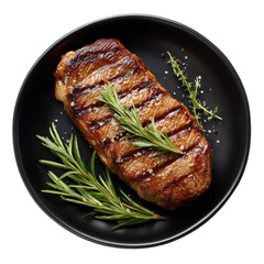 Grilled steak on dark plate with herbs