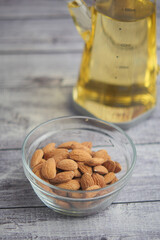 Almonds ready for cooking with oil on wooden surface