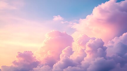 A dreamy cloudscape with fluffy pink and purple pastel color clouds against a soft blue sky