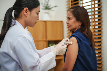 doctor holding syringe and making injection vaccine to patient