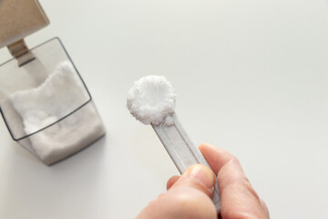 計量スプーンで砂糖をすくう